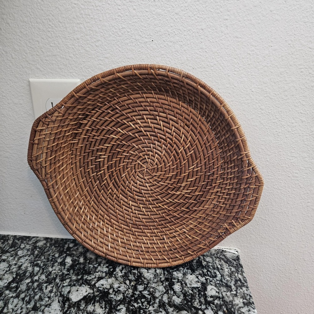 hand-woven rattan tray with a distinct spiral patterns serving plate